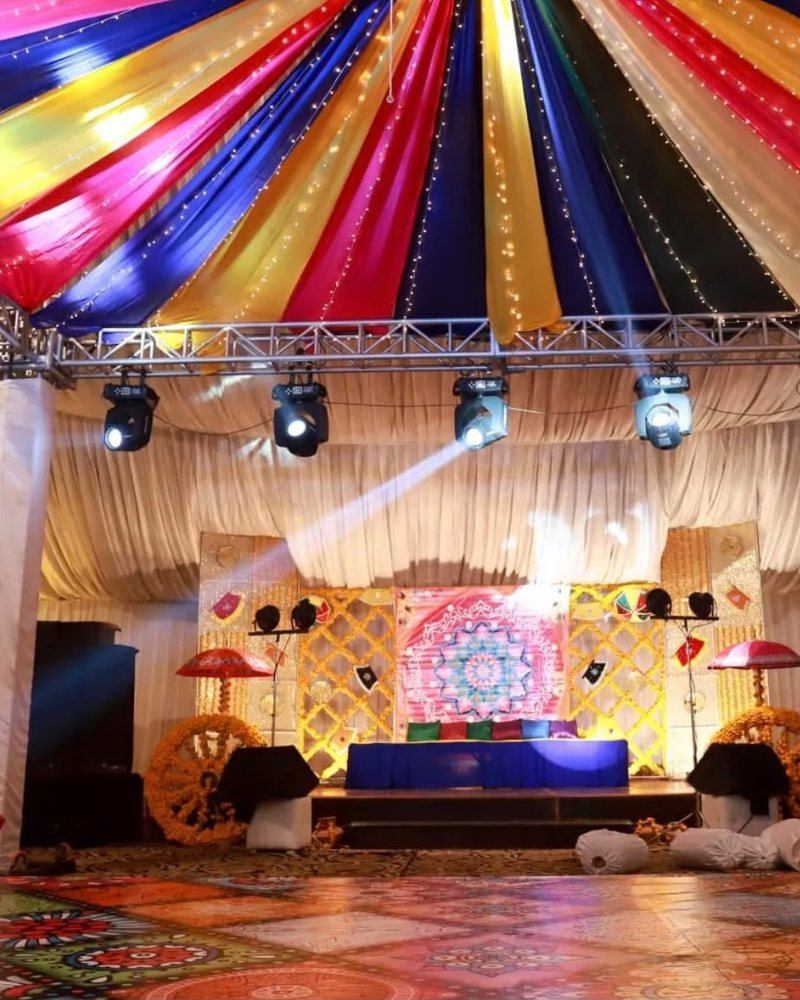 Mayoun stage with coloured canopy and stage lighting by Wedding Alley