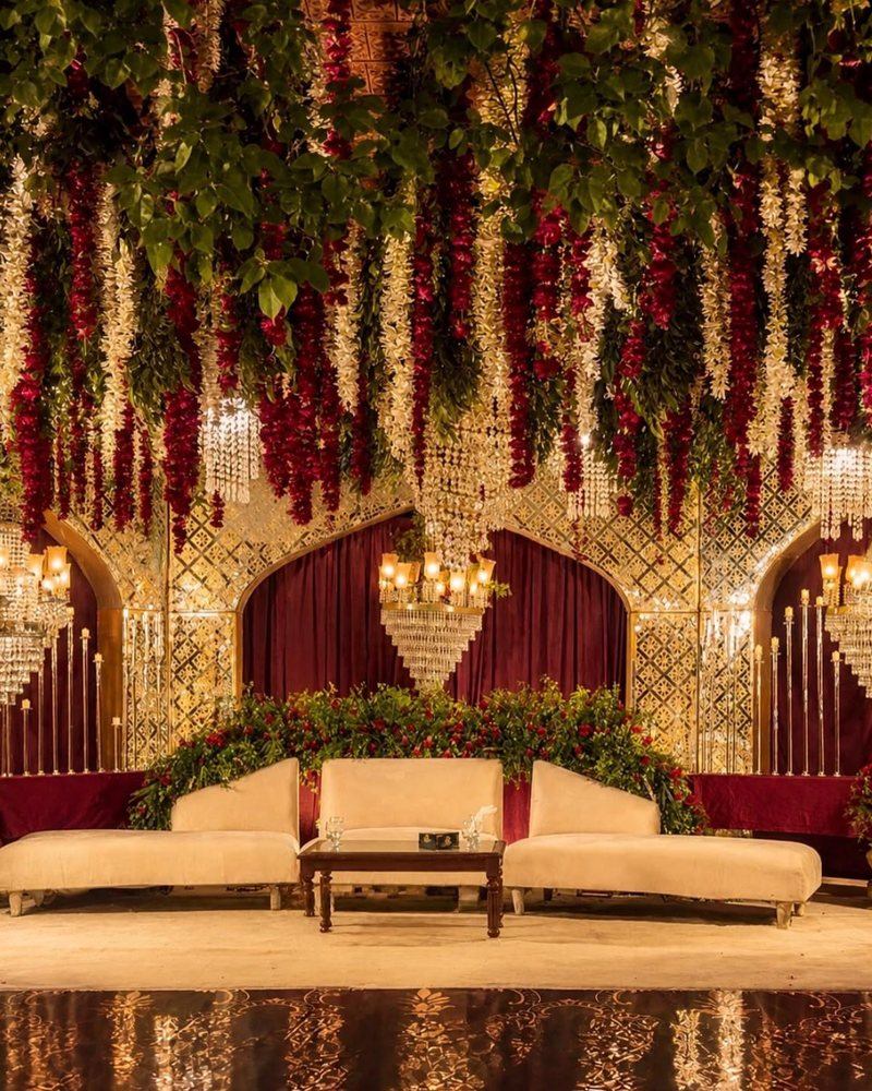 Walima stage in maroon and gold with hanging florals by Wedding Alley