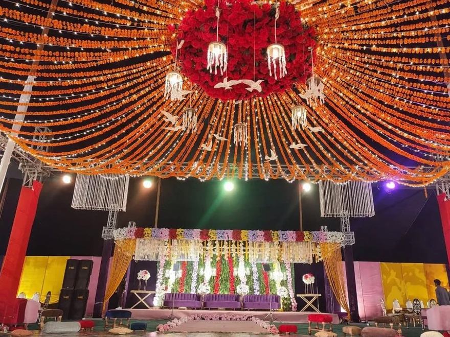 Mehndi canopy of marigold strings under fairy lights by Wedding Alley