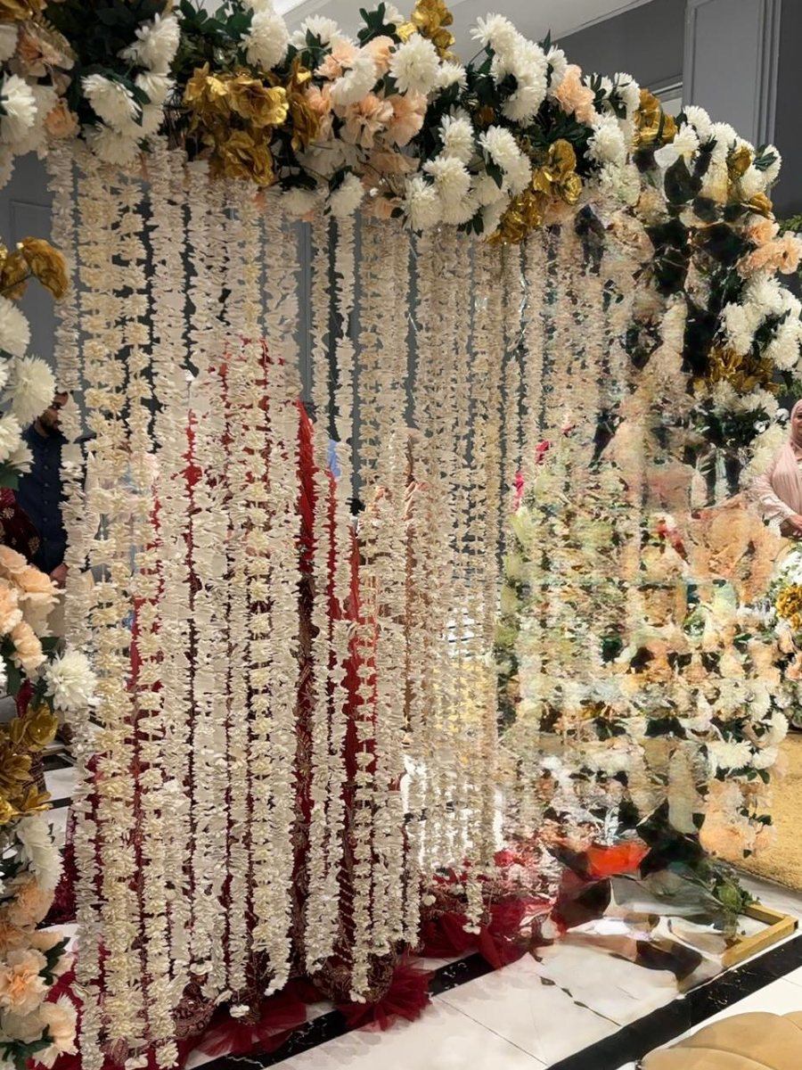 Floral garland backdrop built by Wedding Alley